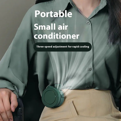 Portable small air conditioner held by a person wearing a green shirt.