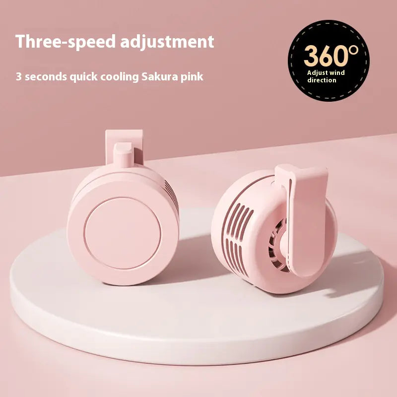 Pink handheld fan with three-speed adjustment and 360-degree direction on a pink background