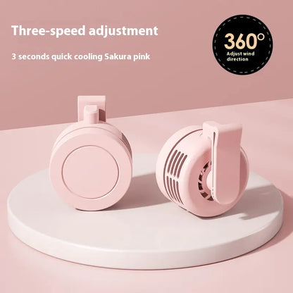 Pink handheld fan with three-speed adjustment and 360-degree direction on a pink background